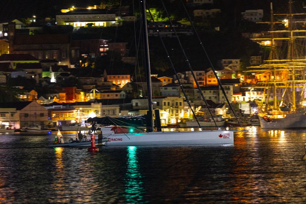 Assisted by the Port Louis Marina team, IMOCA 60 Canada Ocean Racing makes her way through St George's Carenage to a great welcome on the dock © Arthur Daniel/RORC