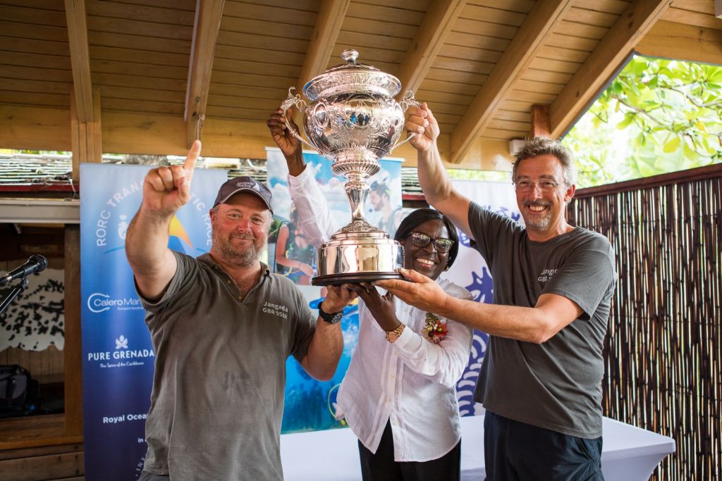 (Right) Richard Palmer's JPK 10.10 Jangada, racing two handed with Jeremy Waitt (left) receive the magnificent  RORC Transatlantic Race Trophy from Dr Clarice Modeste-Curwen, Minister for Tourism and Civil Aviation, Grenada © RORC/Arthur Daniel