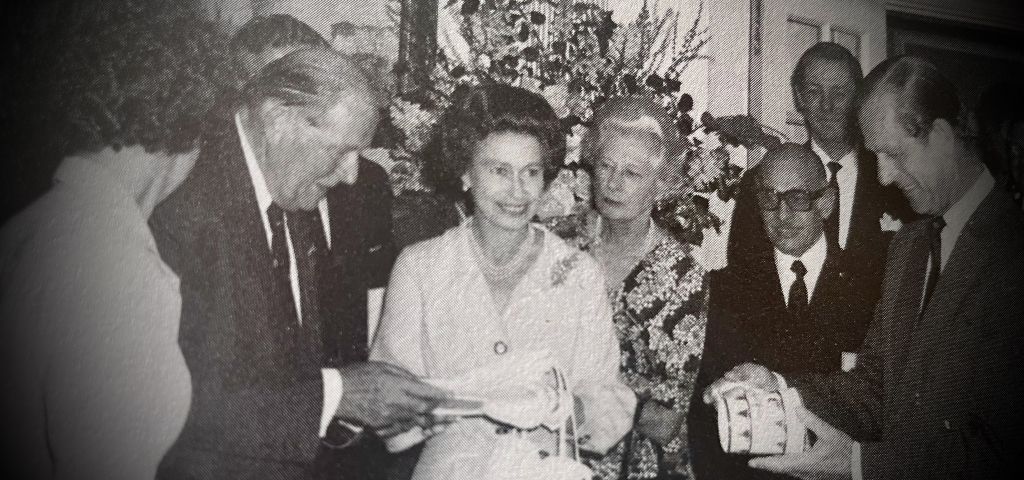 Her Majesty Queen Elizabeth II and Prince Phillip receiving a commemorative mug and plate from the Club’s Admiral Owen Aisher at the RORC London Clubhouse on 21 July 1975 to celebrate the RORC’s 50th Anniversary.