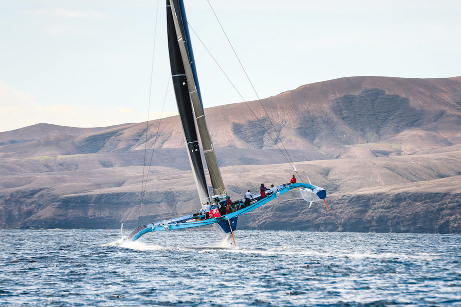 A dramatic backdrop as PowerPlay heads off for the spice island of Grenada after the start of the RORC Transatlantic Race off Puerto Calero Marina, Lanzarote © James Mitchell/RORC